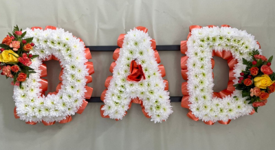 Based DAD letters - A floral funeral tribute to spell DAD, ribbon and top spray colours can be changed.